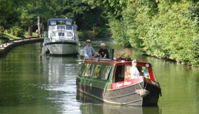 barge and cruiser on the thames