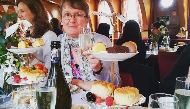 Lady with glass and afternoon tea
