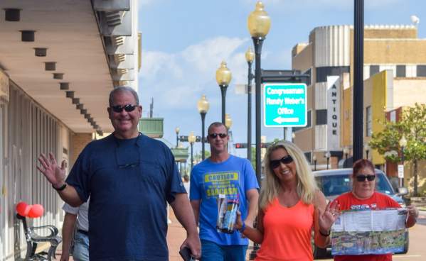 A group of people enjoying touring the geocaching attractions in downtown Beaumont.