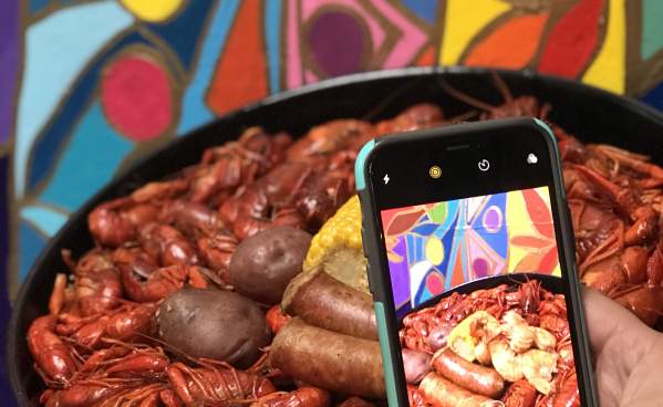 Phone taking a picture of a Beaumont crawfish dish