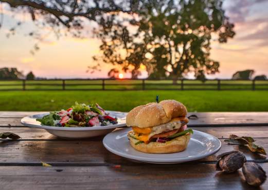 Burger & Salad Dishes with the Sunset at Amelia Farm & Market