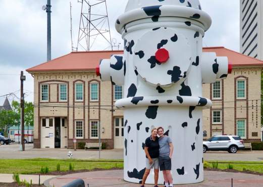 Couple standing by Dalmatian Patterned Fire Hydrant in Beaumont, TX