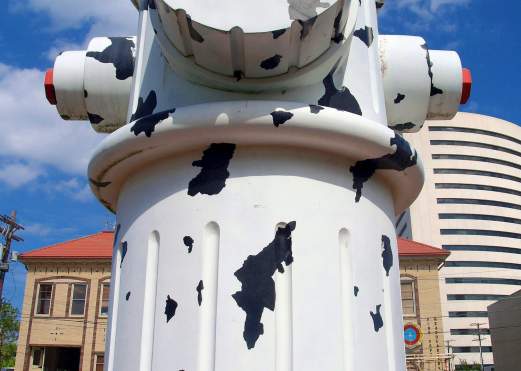 Girl sitting in front of the Giant Fire Hydrant in Beaumont