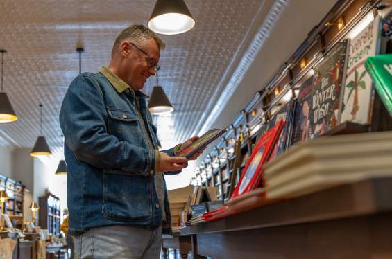 Man looking at book in bookshop