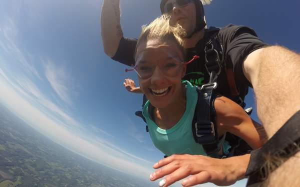Woman Jumps from Plane with Instructor Attached Behind her