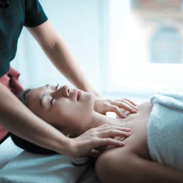 Masseuse Massages Woman's Shoulders