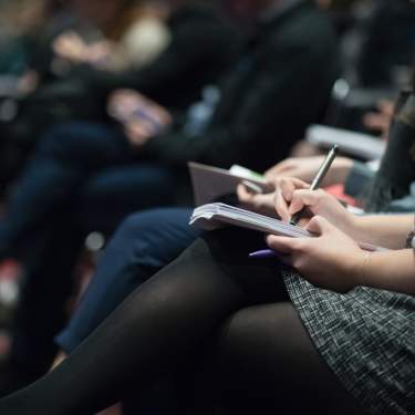 Woman Takes Note At Meeting