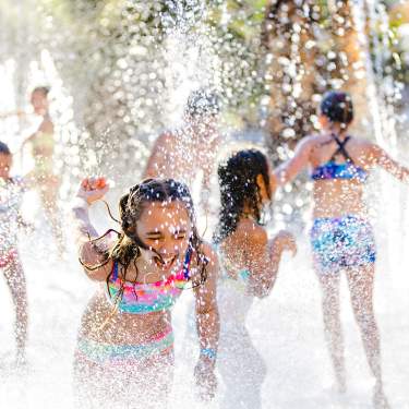 Children play in a splash pad at Hyatt Regency Indian Wells Resort & Spa.