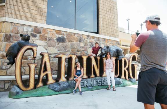 Family in front of Gatlinburg sign