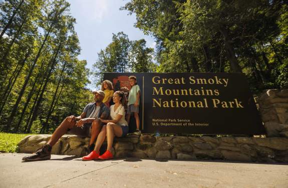 family in front of Smokies sign