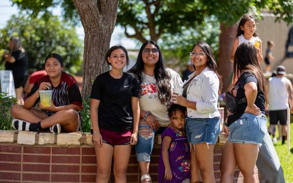 Photo of a family posing for the camera at Pat Coursey park in Downtown Brownwood
