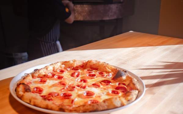 A single serve pizza dish sitting on a countertop at Maillard's inside of Social on Main in Downtown Elizabethtown