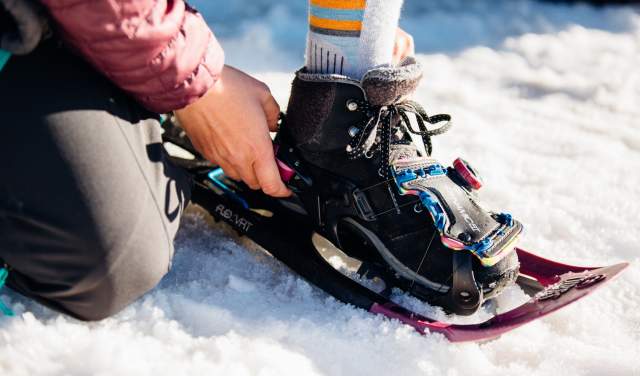 Putting on a snowshoe
