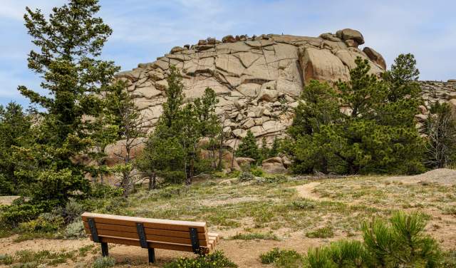 a bench outdoors in front of rock formations at Vedauwoo Recreation Area