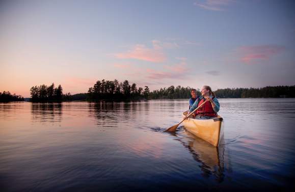 Two people canoeing on an inland lake