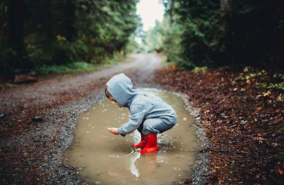 child playing in puddle