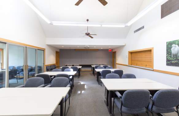 Ashley Center Indoor Facility set up like a meeting room with tables and chairs.