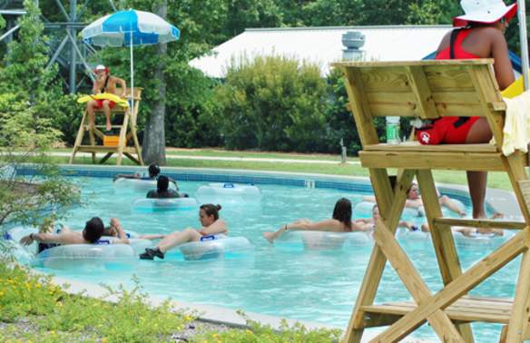 people floating on rafts in the Rollin River lazy river