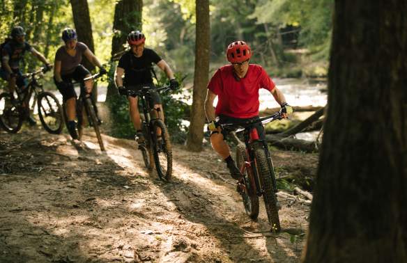 3 cyclists on a bike trail
