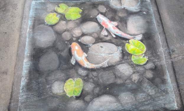 Beautiful chalk art of koi fish in a pond at the Chalk Fest