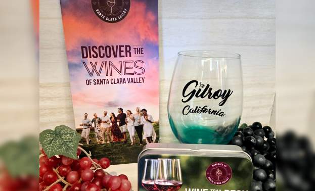 Wine Deck Trail Pass Card Deck in a collectable tin, with a Gilroy logo wine glass, and a "Discover the Wines of Santa Clara Valley" Winery Map displayed with decorative grapes