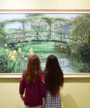 Two girls looking at a painting at R.W. Norton Art Gallery