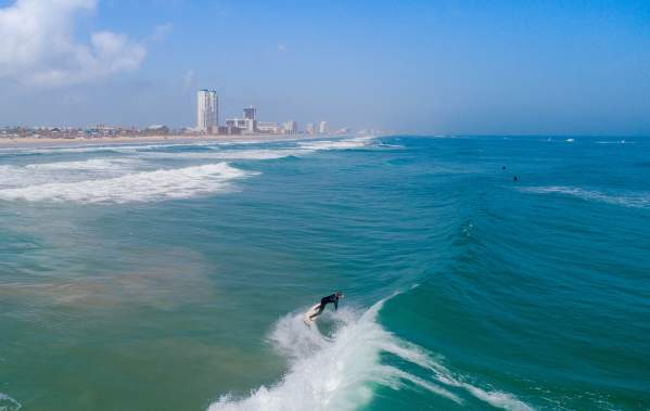 Man surfing off the coast