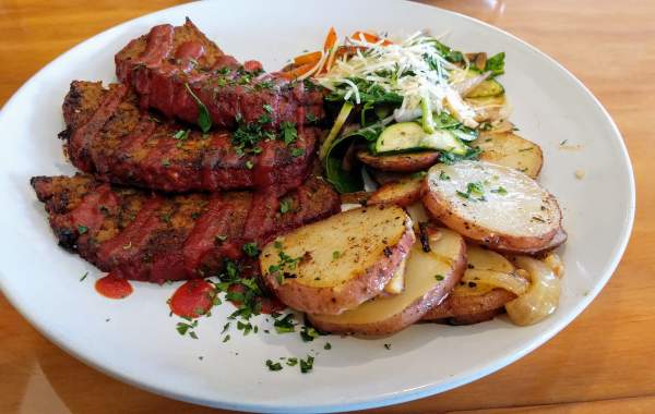 A plate of dutch-oven potatoes, steamed vegetables, and meatloaf from local restaurant Bowman's Cowboy Kitchen in Cedar City, Utah.