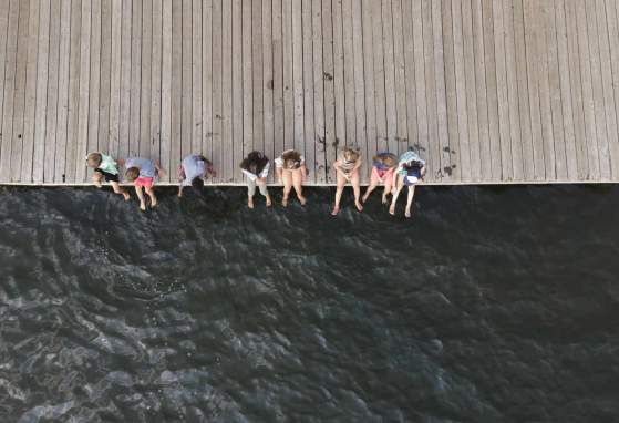 overhead view of people sitting on dock