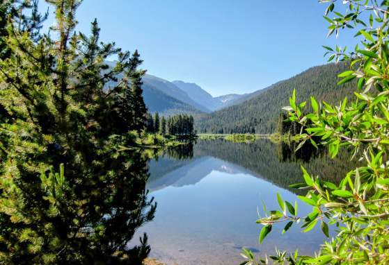 Monarch lake on a clear, sunny day with green foliage in the foreground