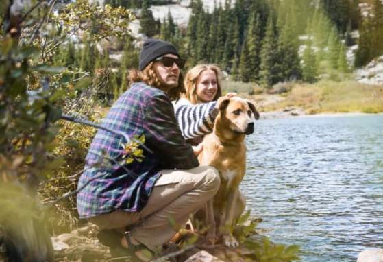 hikers and dog near water