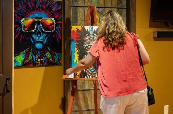 Woman looking at artwork at the Downtown Armory