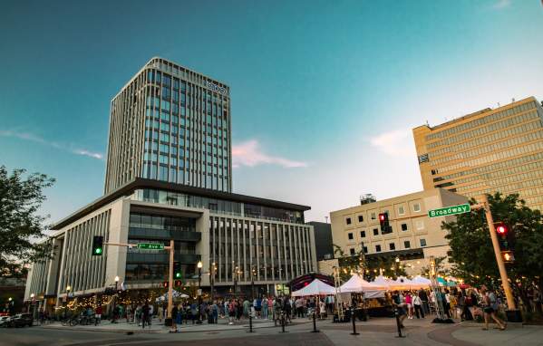 group of people gathering for an event with local vendors in the heart of a downtown