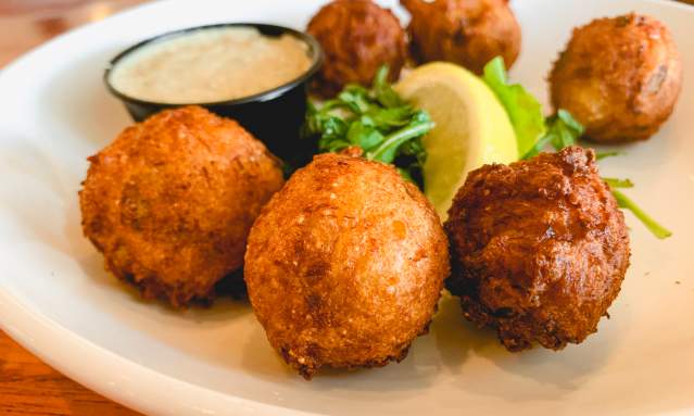 A close up plate of crab hushpuppies