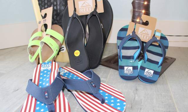 A stack of flip flops in different sizes laid out next to each other