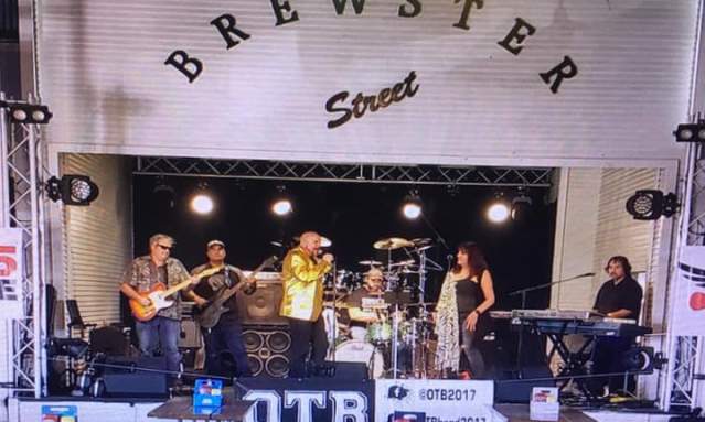 A band performs on a stage labeled "Brewster Street."