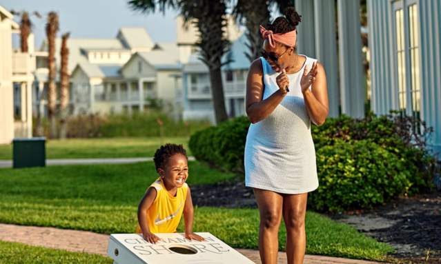 Mother and child playing cornhole in Cinnamon Shore resort