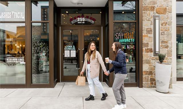 Female couple holding hands outside Cork and Candle in King of Prussia