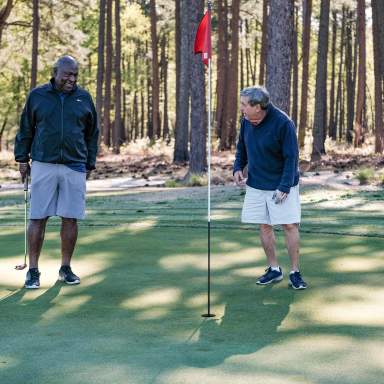 Two men laughing around a golf flag at Cumberland County's Bayonet Golf Course