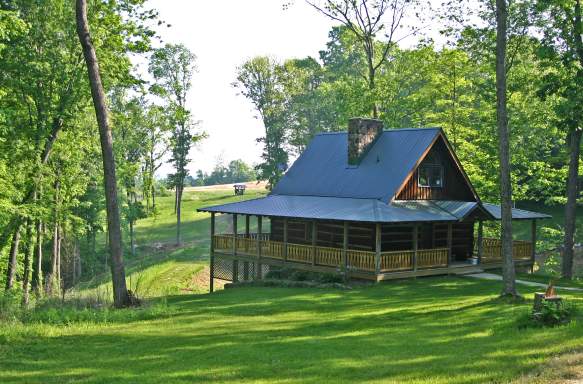 Exterior view of a cabin with a wrap around porch