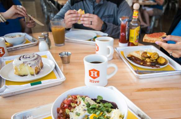 Table of food and Hive coffee cups at Hive Breakfast