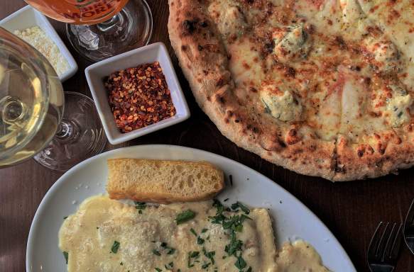 A pizza and a ravioli dish from Osteria Rago