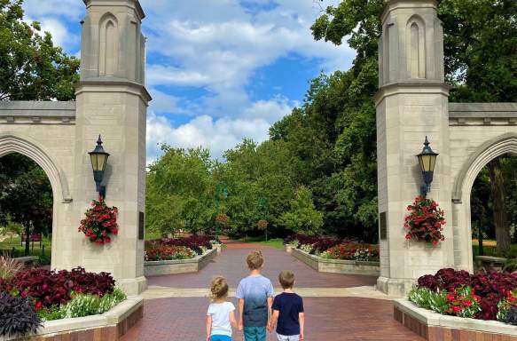 Three small kids holding hands at Sample Gates