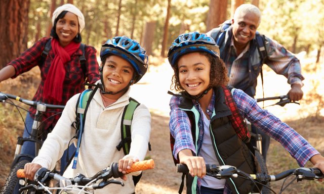 A family enjoys a fall bike ride.