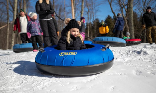 A girl prepares for a snow tubing ride down the hill in the Poconos!