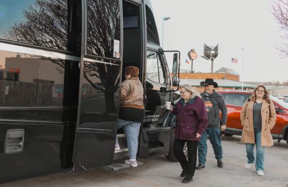 Passengers getting onto a large bus