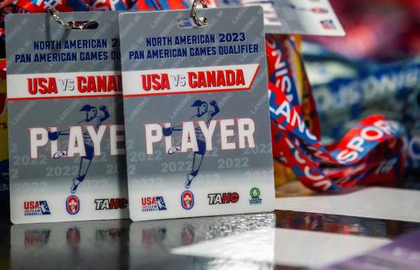 Handball player credentials attached to lanyards sit on a table.