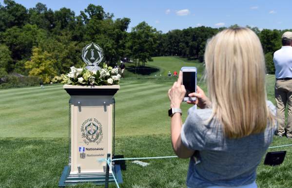 Girl taking a photo of the Memorial Tournament trophy while on course at Muirfield Village Golf Club