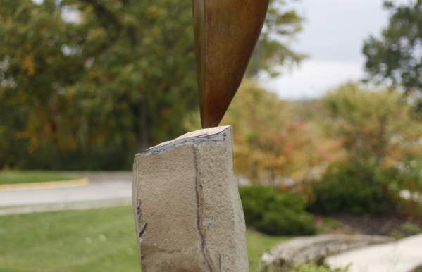 Bronze and stone sculpture on a steel base.