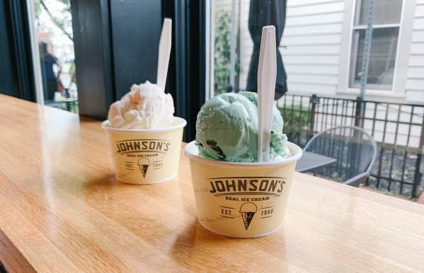 Two Johnson's Ice Cream cups filled with color scoops of ice cream